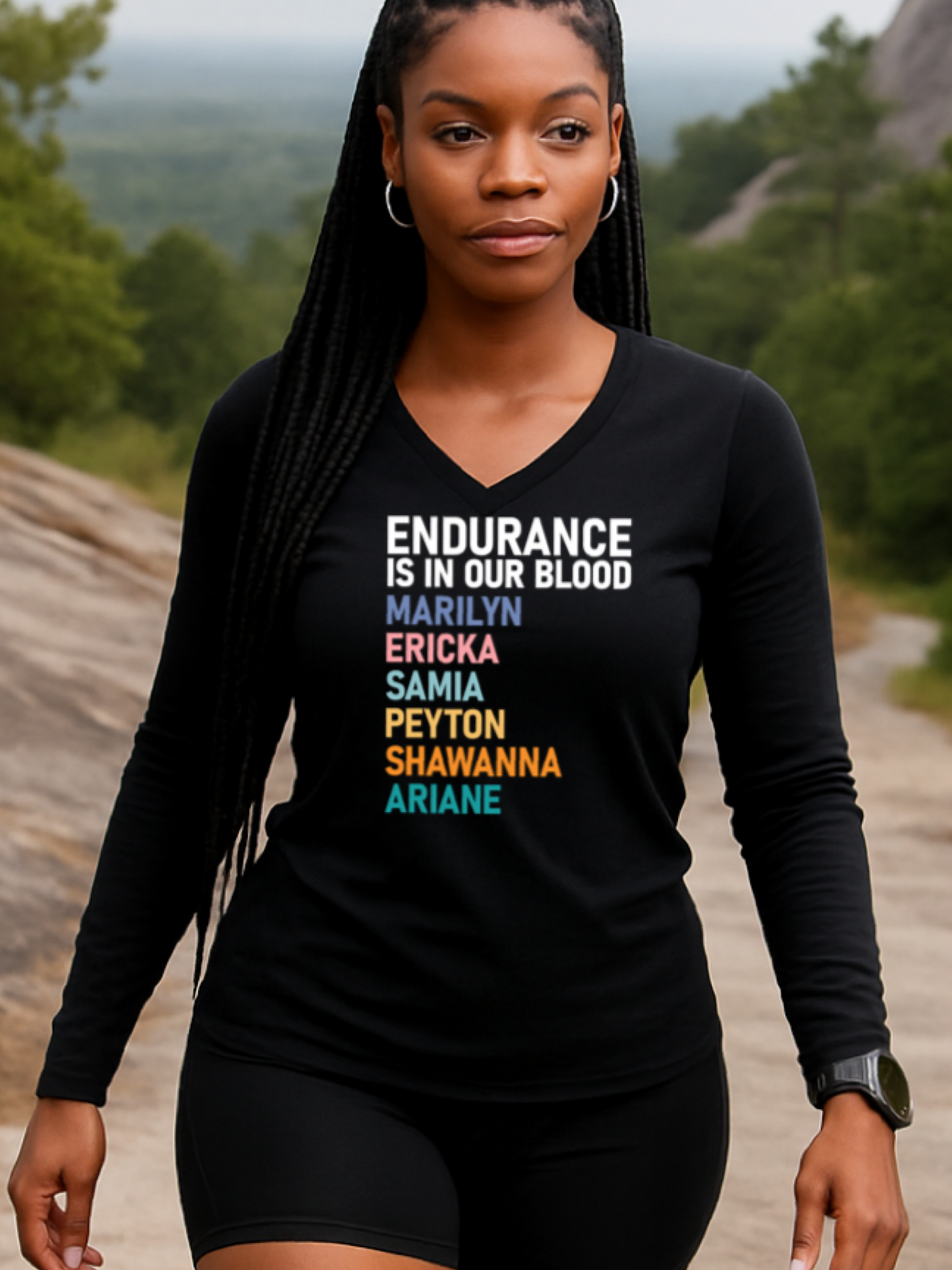 Woman wearing a black long-sleeve shirt with a list of black female marathoners in a scenic outdoor setting