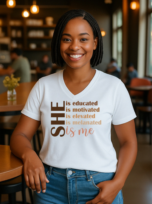 Black girl wearing a white t shirt that says she is me. Melanated Elevated Educated