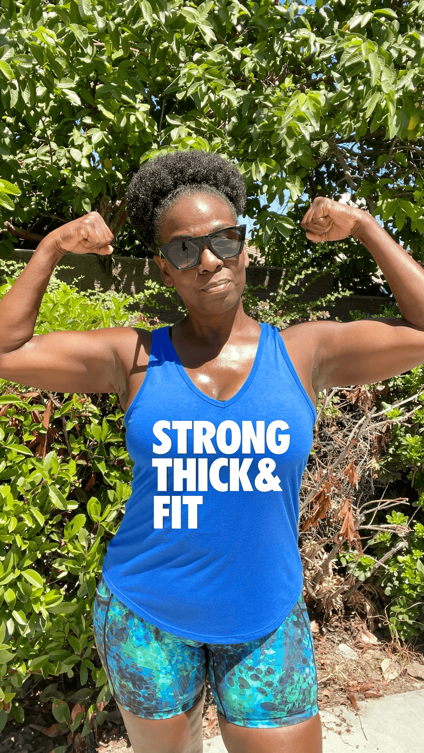 Black Girl Posing in Royal Blue tank top that says Strong Thick Fit