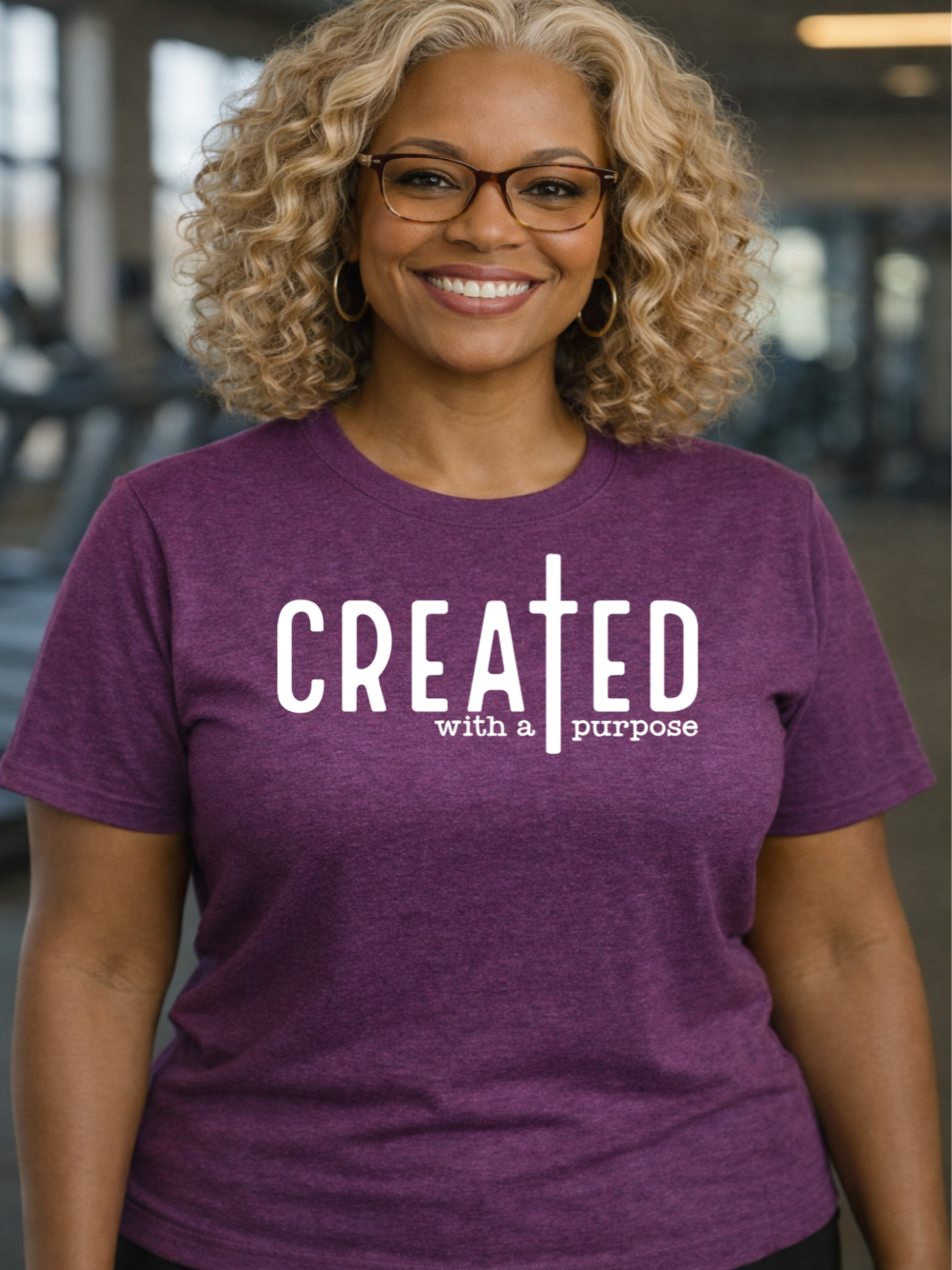 Person wearing a purple t-shirt with 'CREATED with a purpose' text in an indoor setting