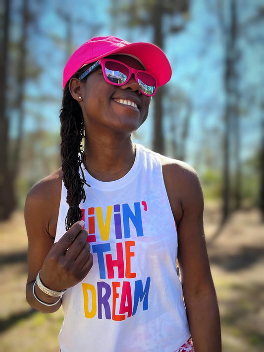 Girl in running hat and livin the dream crop tank top 