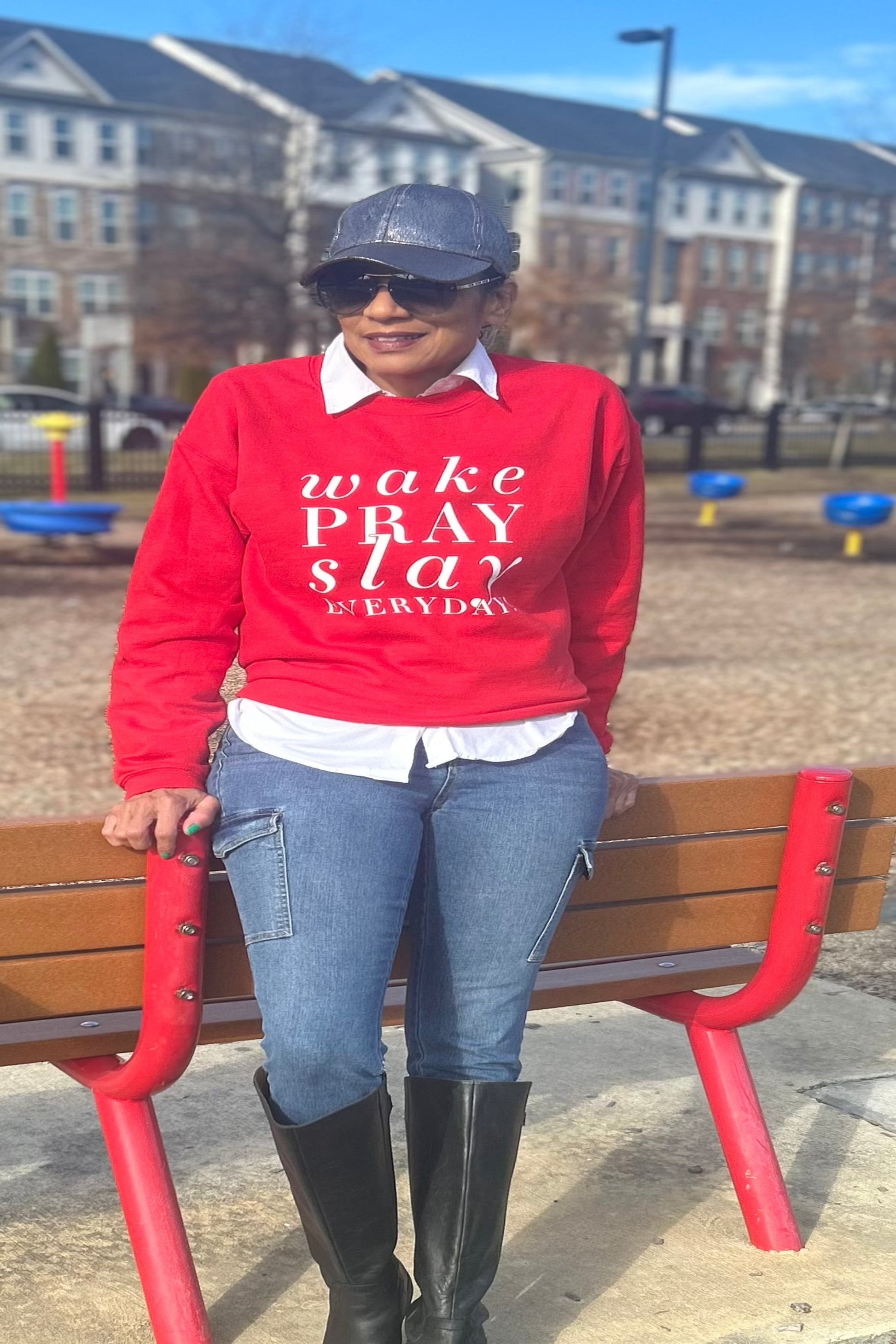 Black girl in a Wake pray slay red sweatshirt standing outside  