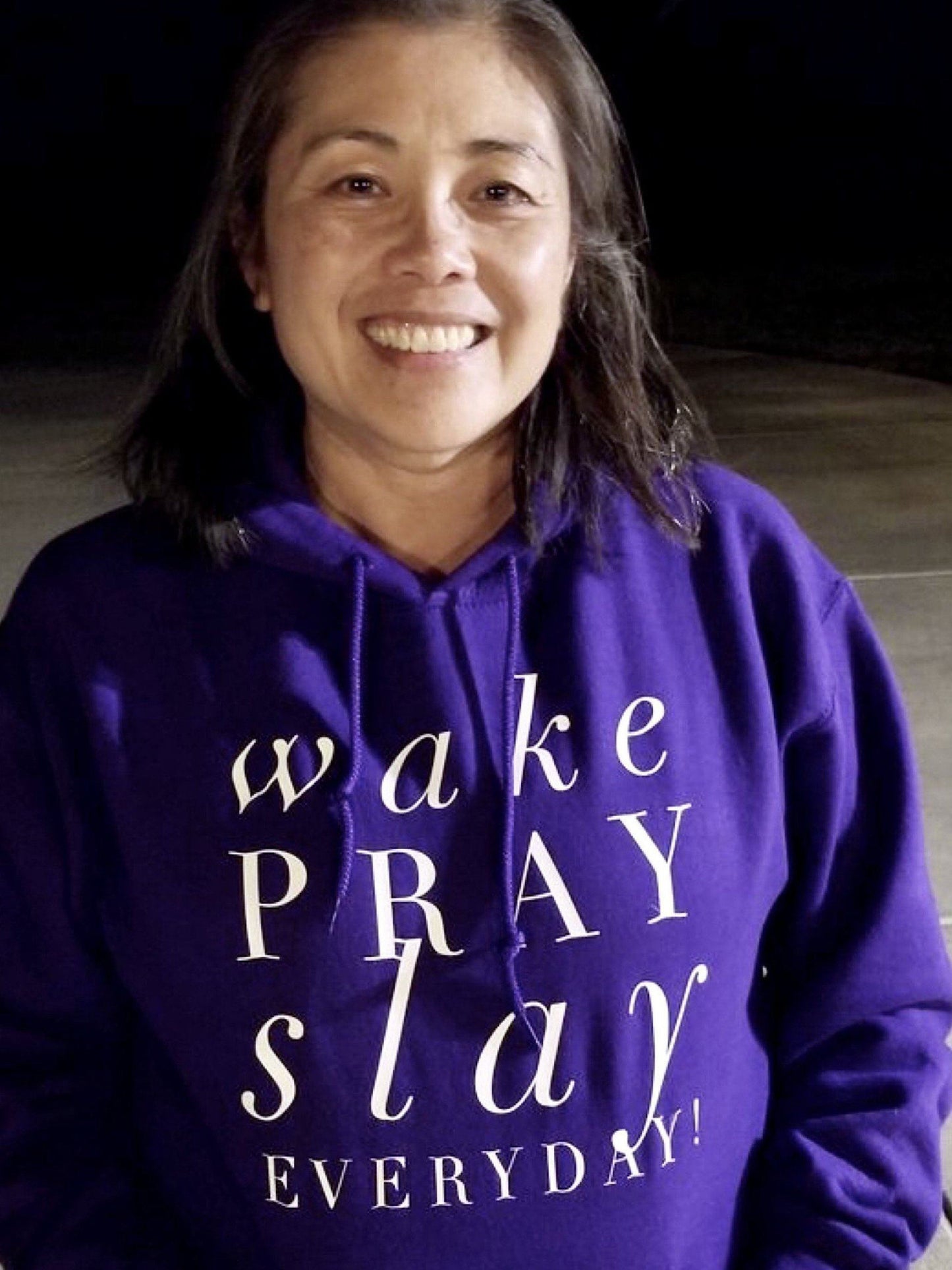Person wearing a purple hoodie with motivational text