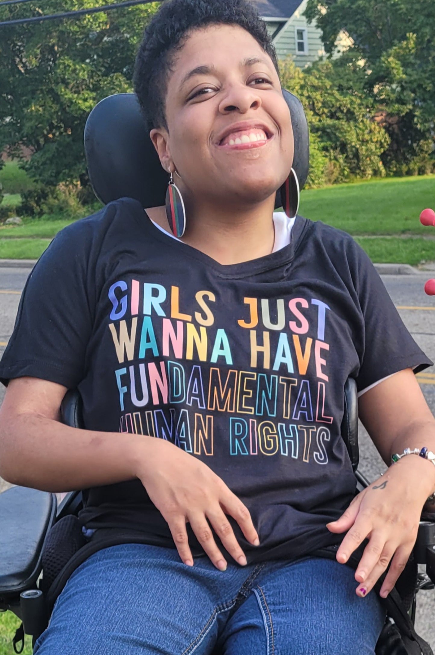 Young Girl in wheel chair wearing a Girls Just Wanna Have Fundamental Human Rights Black T-shirt 