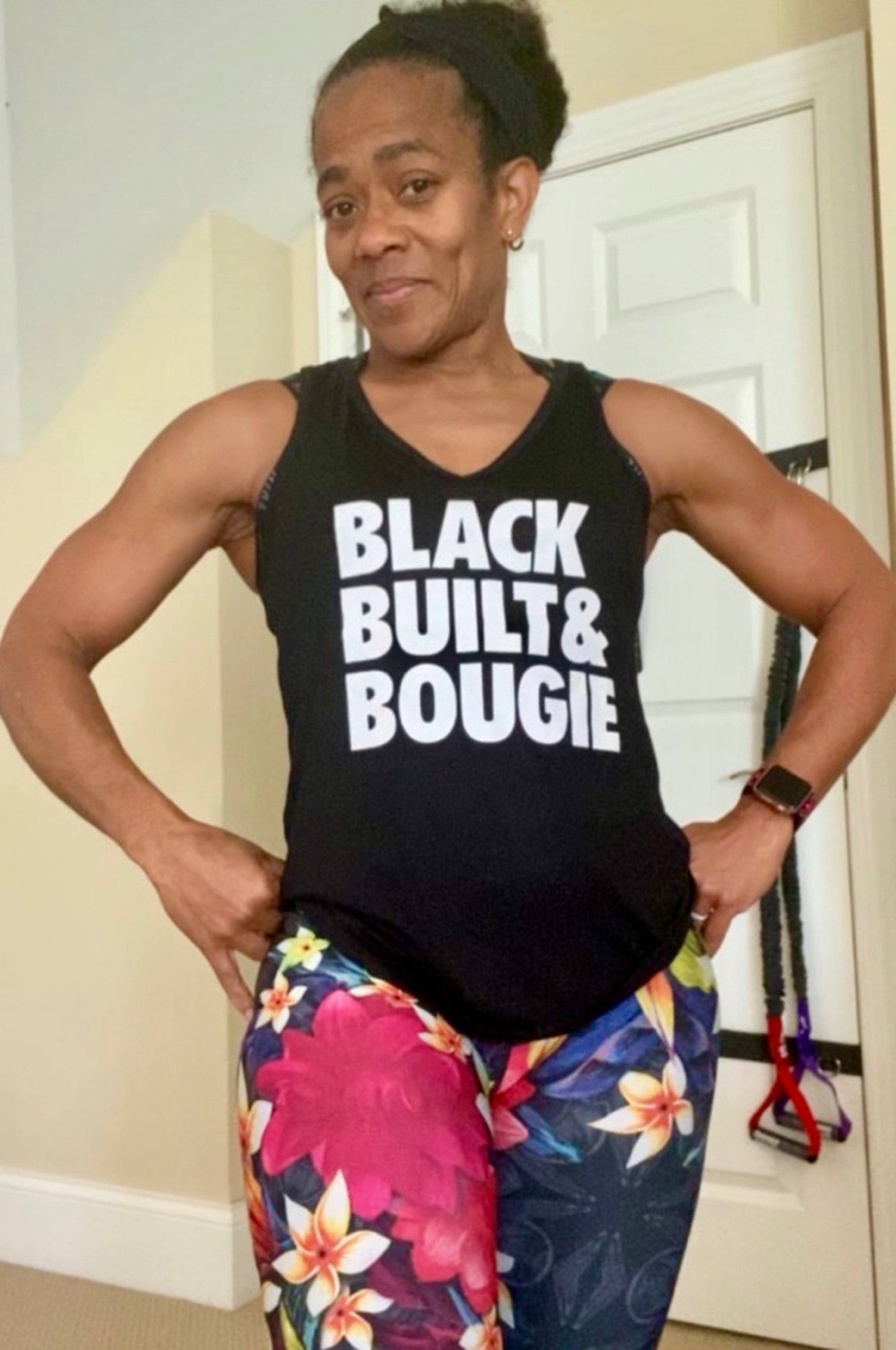 Black girl wearing a black tank top that says Black Built and Bougie