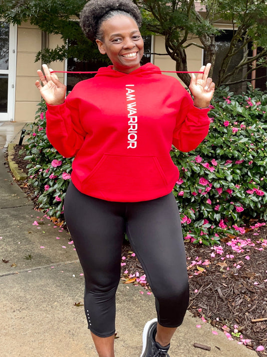 Girl wearing a red hoodie that says I Am Warrior