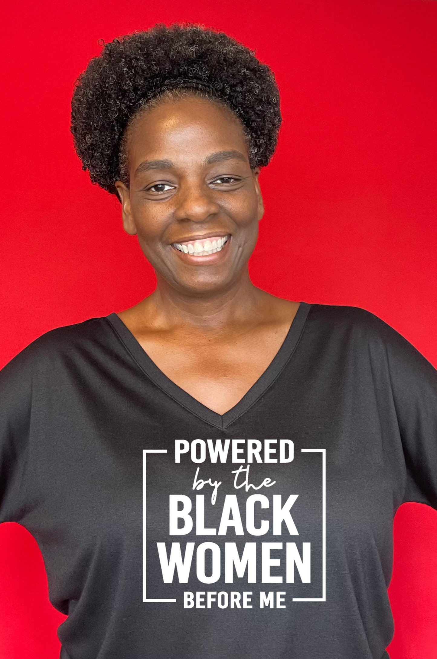 Black T-shirt that says Powered By The Black Women Before Me