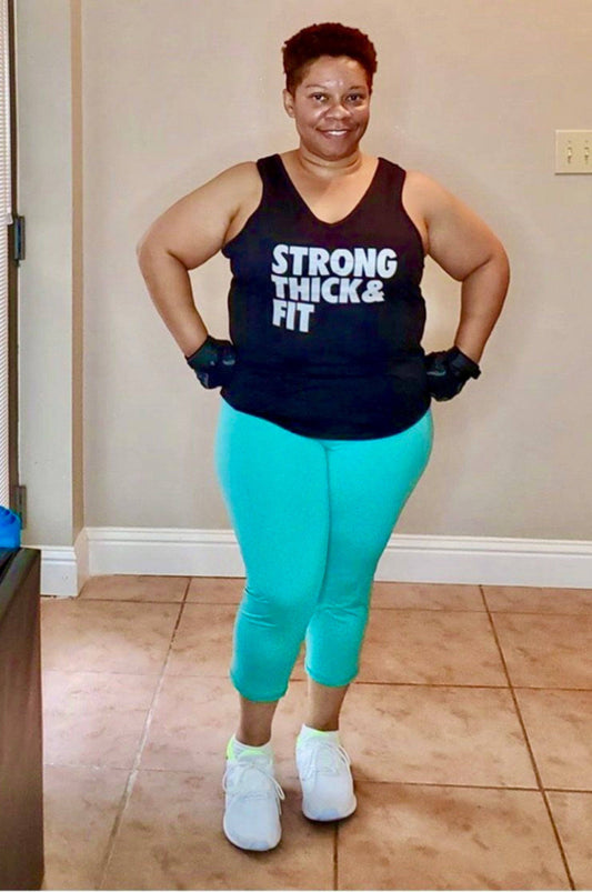 African American girl wearing Black strength training tank top. The tank top says Strong Thick Fit 